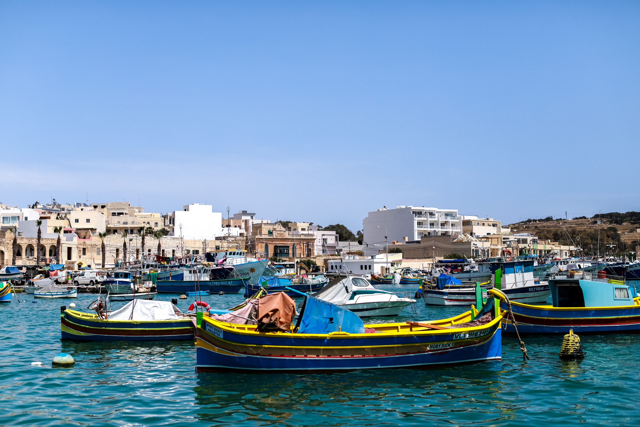 Colourful luzzu fishing boats in Marsaxlokk harbour