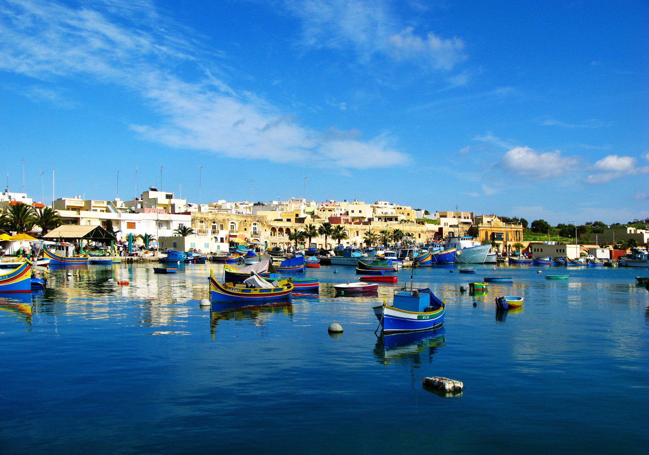 Marsaxlokk harbour with traditional fishing boats in southern Malta