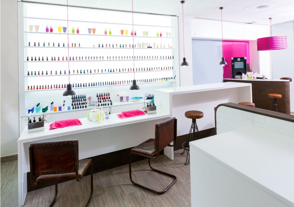 Modern nail salon premises in Malta with manicure stations and product displays