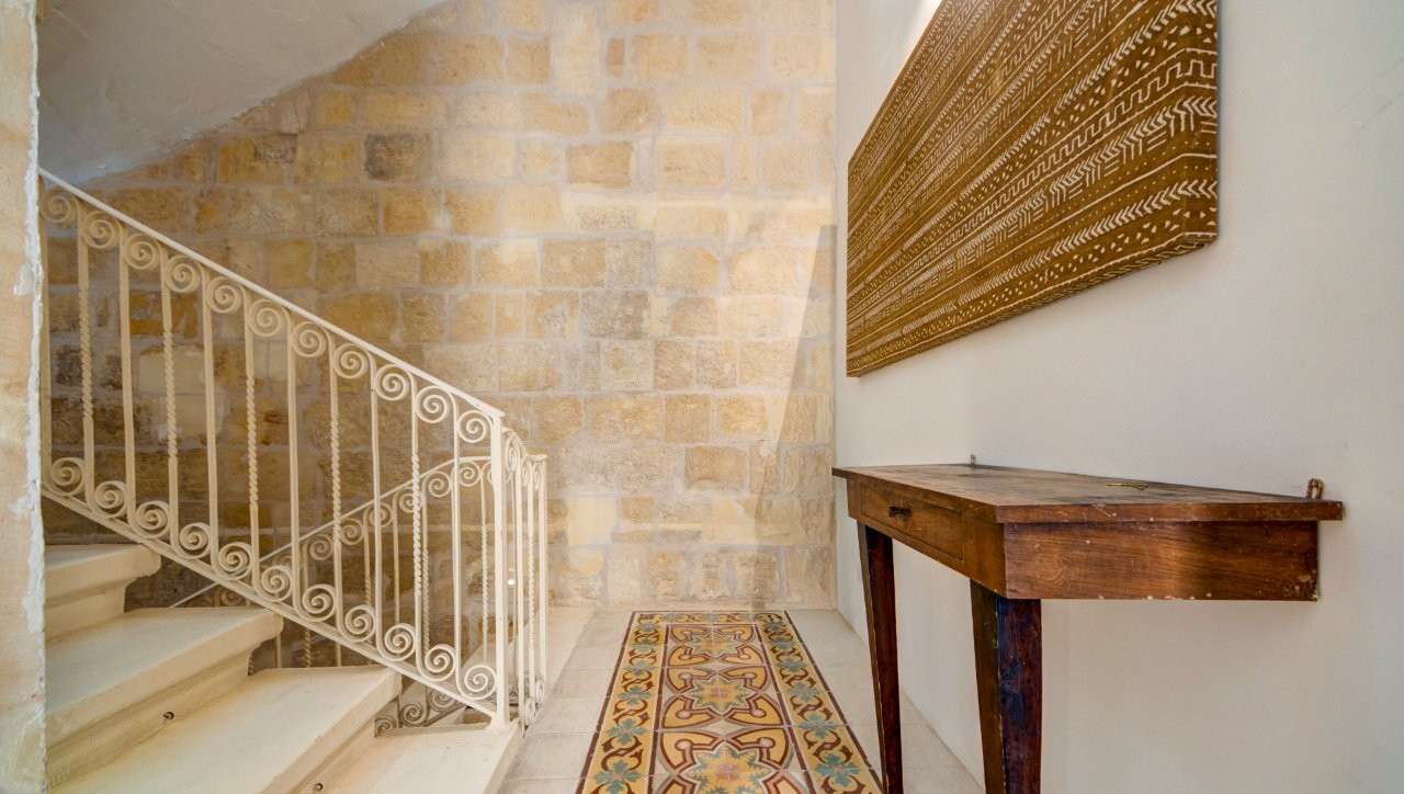 Restored Maltese townhouse staircase with traditional stonework